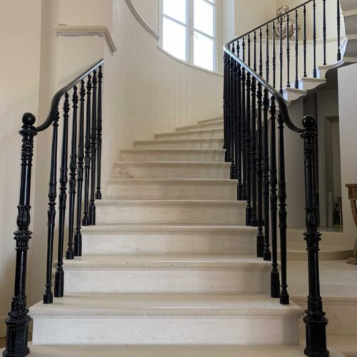 BLACK CAST IRON RAILINGS ON MARBLE STAIRCASE